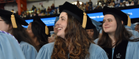 Female graduate sitting in a crow at graduation